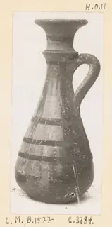 Pottery jug with a flared rim, single loop handle and dark painted bands