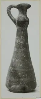 Pottery jug with a loop handle, tall neck and flaring rim, shown upright against a plain background