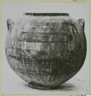 Round-bodied painted pot with two handles and rows of concentric circle motifs