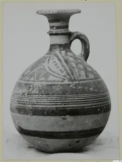 Jug with a flared rim, loop handle and painted bands, with a panel of curved and dotted motifs on the shoulder