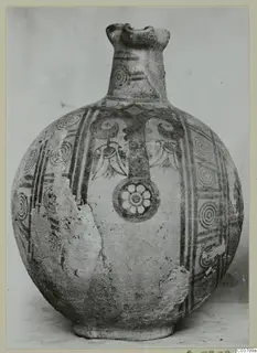 Round-bodied painted jug with a trefoil mouth, its body decorated with concentric circles, bands and a flower roundel.