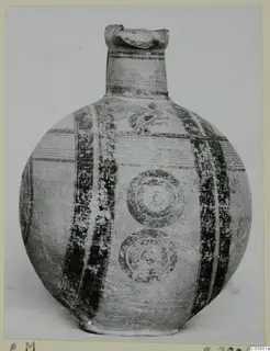 Jug with a round body, a tall neck and dark painted bands, with a bird-like motif on the upper body