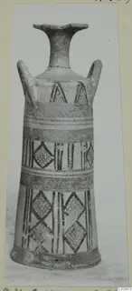 Painted pottery vessel with a flaring rim, two handles, and bands of lozenges, triangles and vertical stripes, photographed upright.