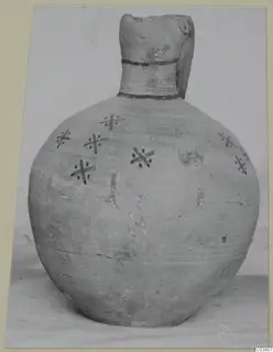 Round-bodied jug with a tall neck and dark cross-shaped painted motifs with dots on its shoulder and body