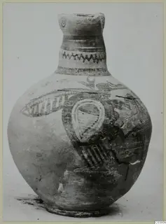 Painted jug with a tall neck, zigzag bands on the neck and large dark motifs on a pale, rounded body.