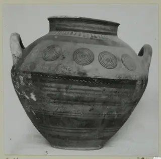 Large two-handled jar with a wide mouth, dark painted bands and four concentric circles on the shoulder.