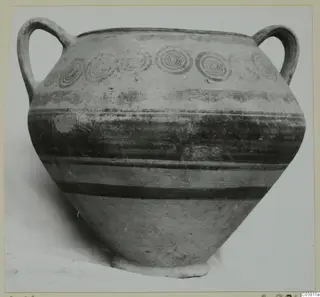Two-handled painted pottery jar with concentric circle motifs on the shoulder and dark horizontal bands on the body.