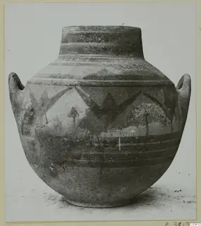 Large painted jar with two handles and a narrow neck, decorated with dark bands and angular motifs.
