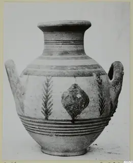 Painted pottery vessel with two handles, photographed from the side against a plain background