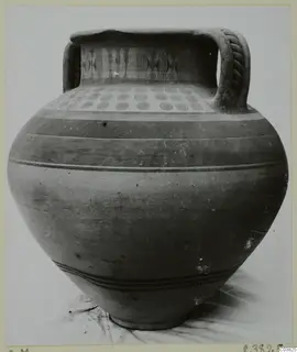 Amphora-crater with painted concentric circles on the shoulder and zigzag bands on the neck, photographed against a plain background