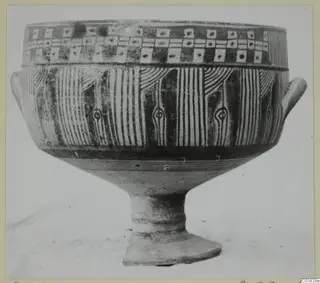Painted pottery vessel on a high foot, with two small side handles and bands of vertical stripes and square panels