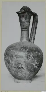 Pottery Bichrome III jug with a globular body, tall neck and loop handle, painted with bands and motifs