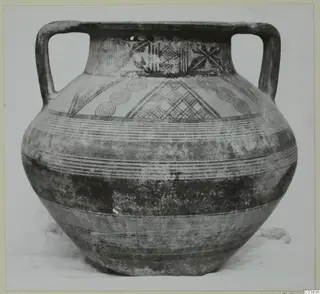 Two-handled painted jar with concentric circles and cross-hatched panels on the shoulder and neck