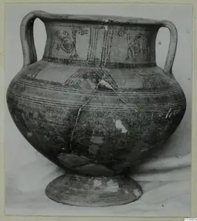 Two-handled painted pottery vessel on a ring foot, with bird-like motifs and stripes on the neck panel and bands on the body.