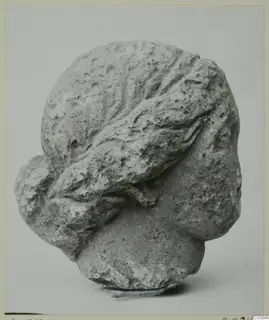Carved stone head with wavy hair swept back, from Soli