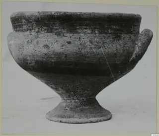Pottery White Painted III-1, a stemmed bowl with two handles, photographed from the side against a pale background