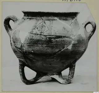 Three-legged White Painted III-1 pottery vessel with two loop handles and painted bands