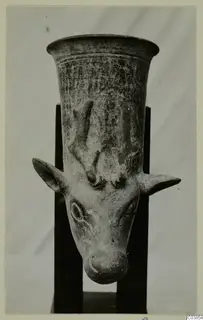 Pottery vessel with a flaring rim and a modelled animal head with ears and horns projecting from its body