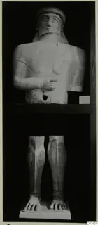 Terracotta statue from Tomassos, shown as an upper body with head and legs with feet on two shelves