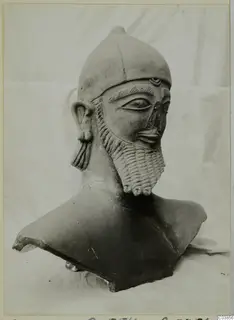 Terracotta bust of a bearded male head in a close-fitting cap, seen three-quarter view against a pale cloth.