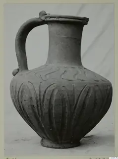 Hellenistic Wares jug with a strap handle, wavy pattern on the shoulder and vertical grooves on the body