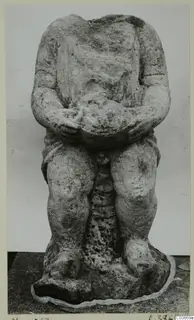 Headless stone sculpture of a seated figure with hands clasped over the lap, from Mersinaki.