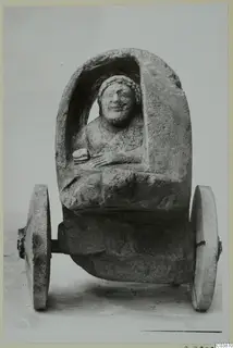 Limestone model cart from Mersinaki with a seated female figure under an arched canopy