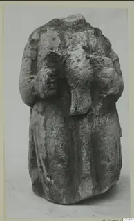 Limestone sculpture of a draped standing figure from Mersinaki, its top broken away
