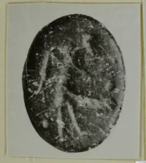 Oval engraved stone seal or gem with a faint standing figure, shown face-on