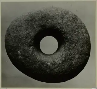 Ring-shaped stone object with a large central hole, photographed from above