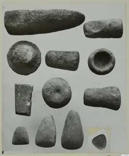 Stone objects from Kythrea: cylinders, bowl-like pieces and smooth rounded pieces on a card mount