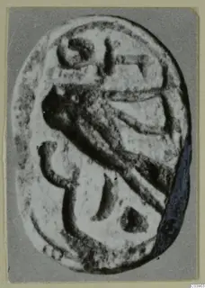 Enlarged photograph of an oval engraved seal from Amathus, with a carved design of curved and angular lines.