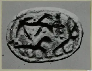 Oval seal or seal impression from Amathus with an incised pattern of bands, angular shapes and small square recesses