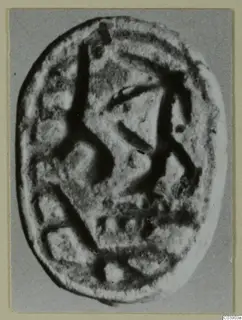 Engraved oval seal from Amathus, photographed face-on against a grey backdrop