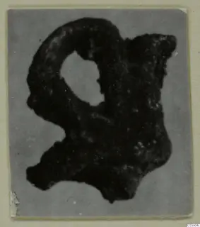 Corroded bronze fragment with a loop, from Amathus.