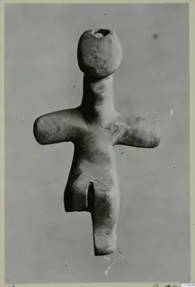 Steatite idol from Kythrea, a small standing figure with outstretched arms and a pierced head