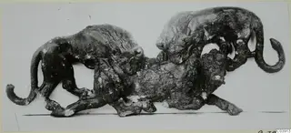 Bronze group of two maned, feline animals attacking a larger animal lying between them