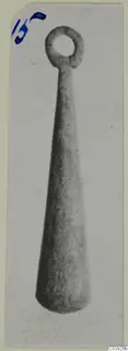 Tapering object with a ring-shaped loop at the top, shown upright on a card mount