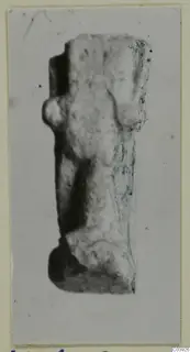 Worn, pale fragment of a figure from Vouni, shown upright on a mounted photograph