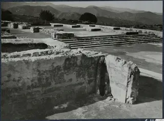 Ruined stone walls and a flight of steps at Vouni palace, with hills in the background.