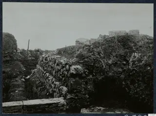 Excavated theatre at Soli with a rough stone wall, a trench and squared stone blocks