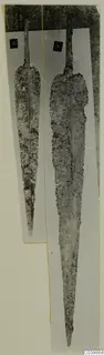 Two corroded metal blades with number labels, from Lapithos Tomb 322B