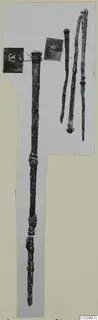 Four slender bronze rods with knobbed heads, from Lapithos Tomb 322 D, photographed on a grey card mount.