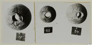 Three round perforated objects with incised grooves from Lapithos Tomb 322 D, each beside a numbered tag