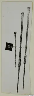 Three long bronze tools from Lapithos Tomb 323 C, with a number label tied on by thread