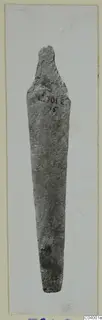 Corroded metal tool with a long tapering blade, from Lapithos.