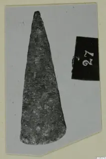 Find of a tapering blade-like object from Lapithos, Vrysi tou Barba tombs, shown beside a number label.