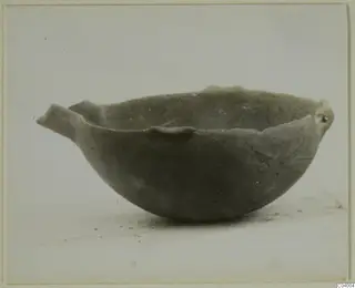 Pottery Red Polished III bowl with a small projecting handle and a rounded body, shown against a pale background.