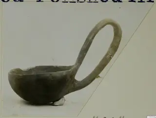 Deep bowl with a tall loop handle, photographed in side view on a pale background