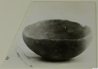 Red Polished III bowl from Lapithos, Vrysi tou Barba tombs, seen from the side on a pale surface